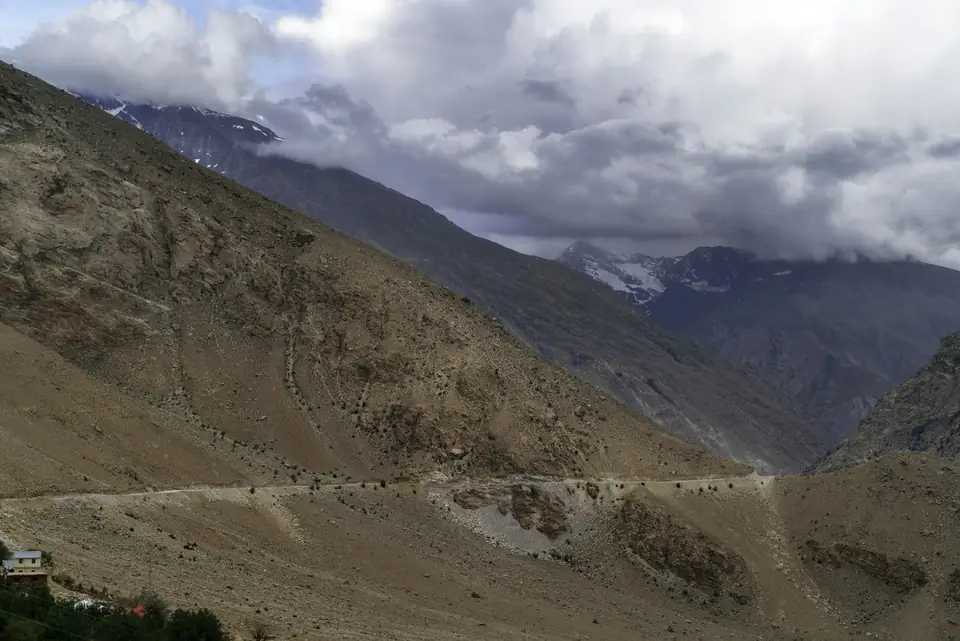 A mountain road winding through the high desert landscape of Spiti